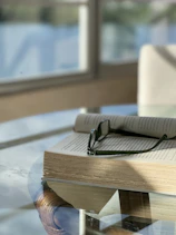 an open book with a pair of glasses on top of it