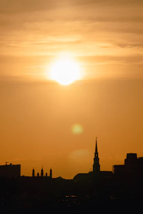 A warm sunset over Buffalo's skyline with the iconic grain elevators glowing softly.