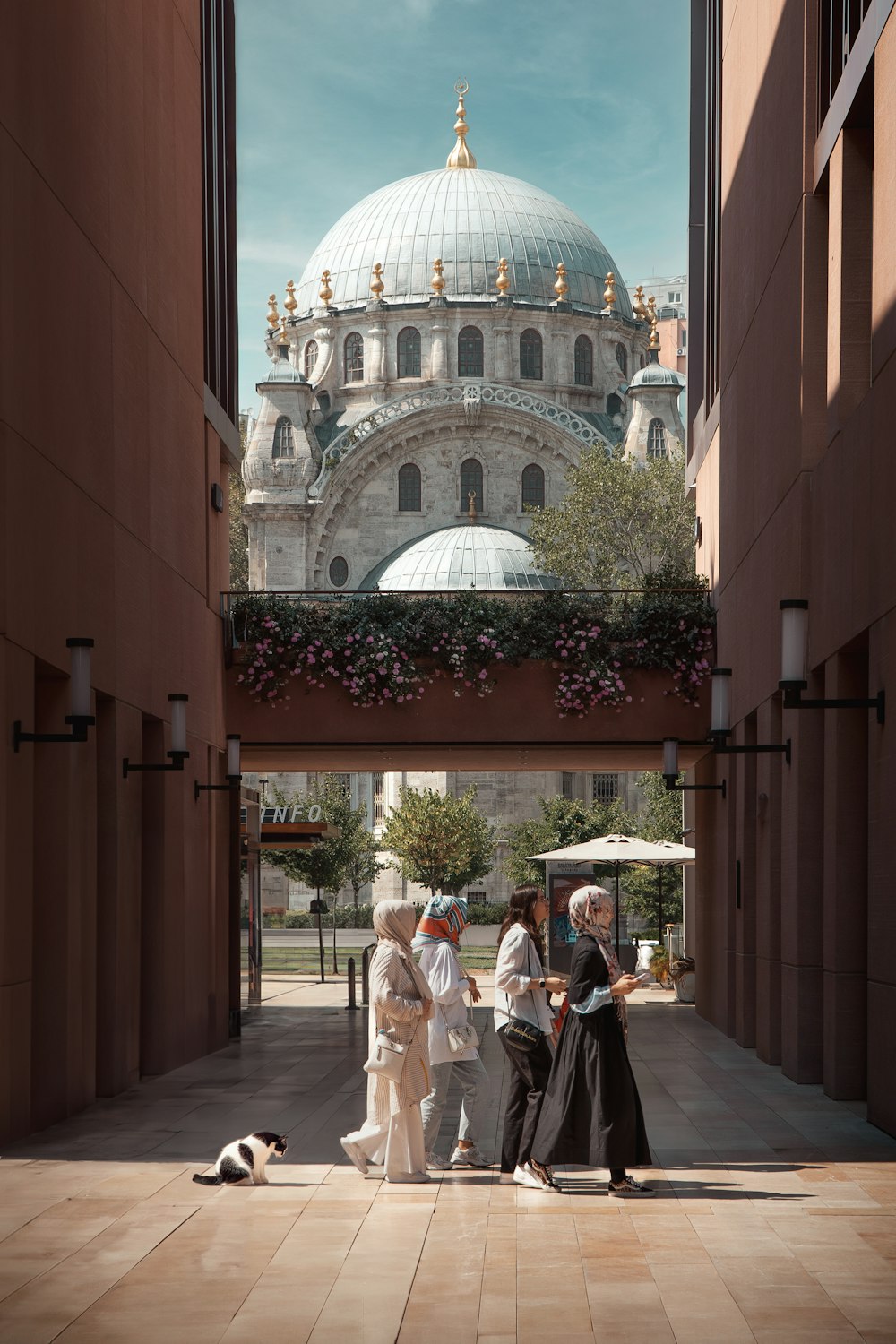 a group of people standing in a courtyard next to a building