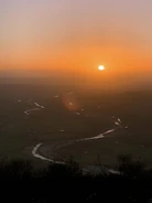 A serene landscape of Punjab’s five rivers meeting under a golden sunset.