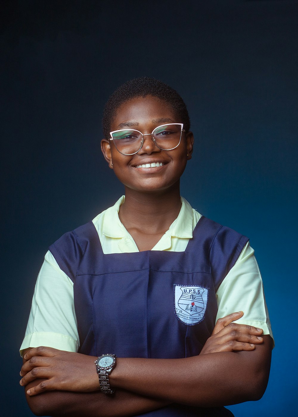 a woman wearing glasses and a blue apron