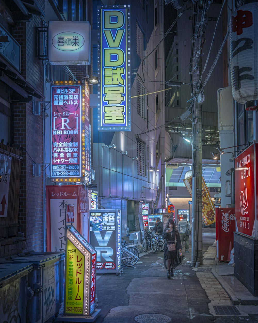 a person walking down a city street at night