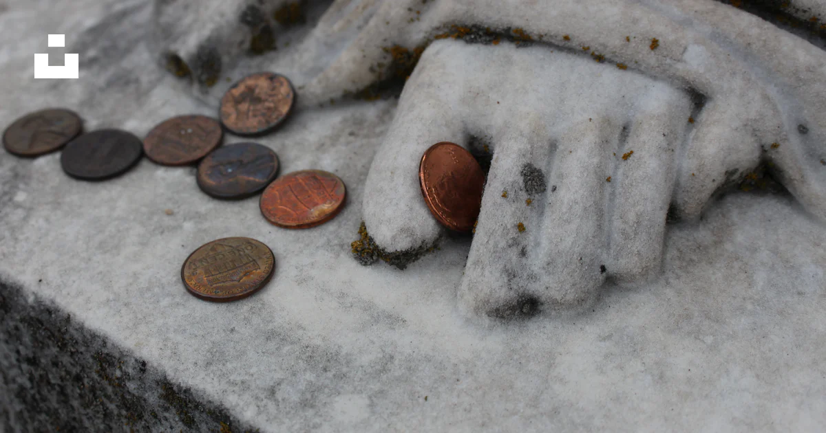 Coin Stack Statue A close up of a statue with a lot of coins photo – Free Money Image on ...