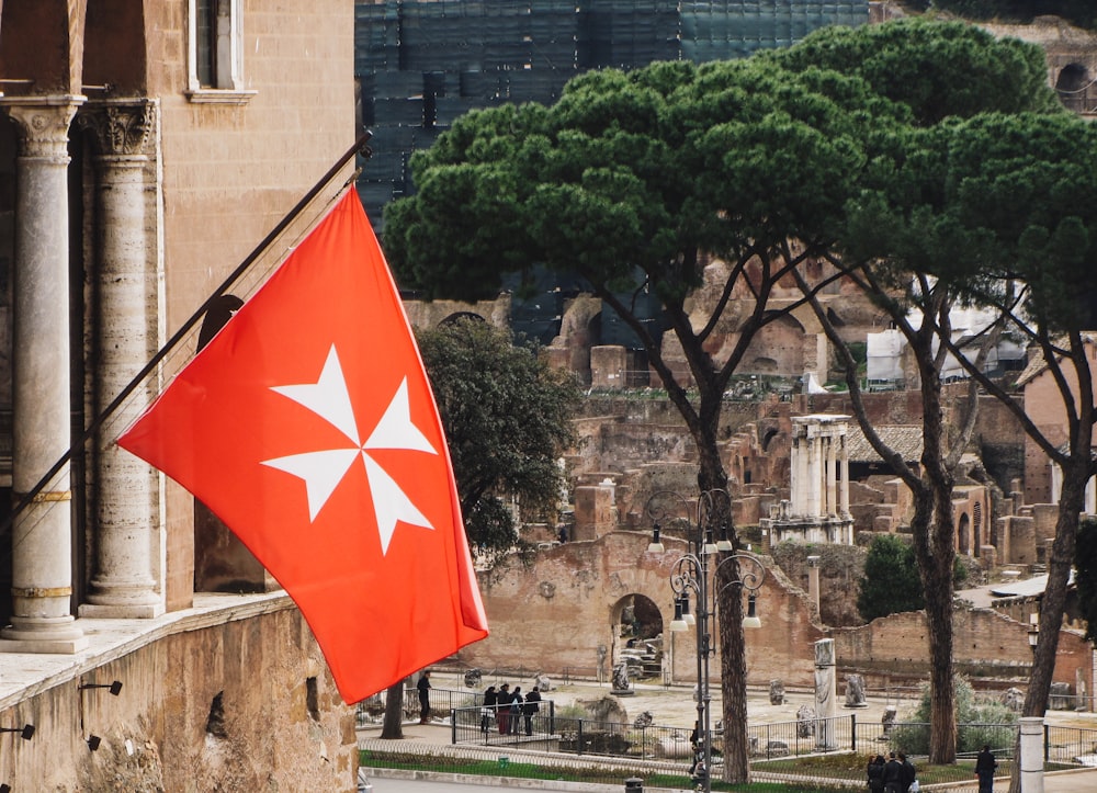 a red and white flag with a star on it