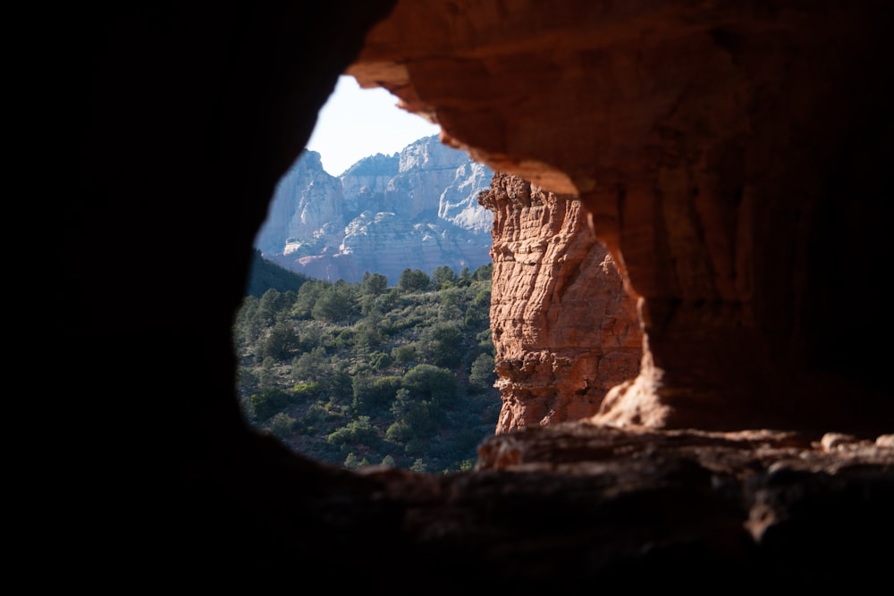 a view of a mountain through a cave