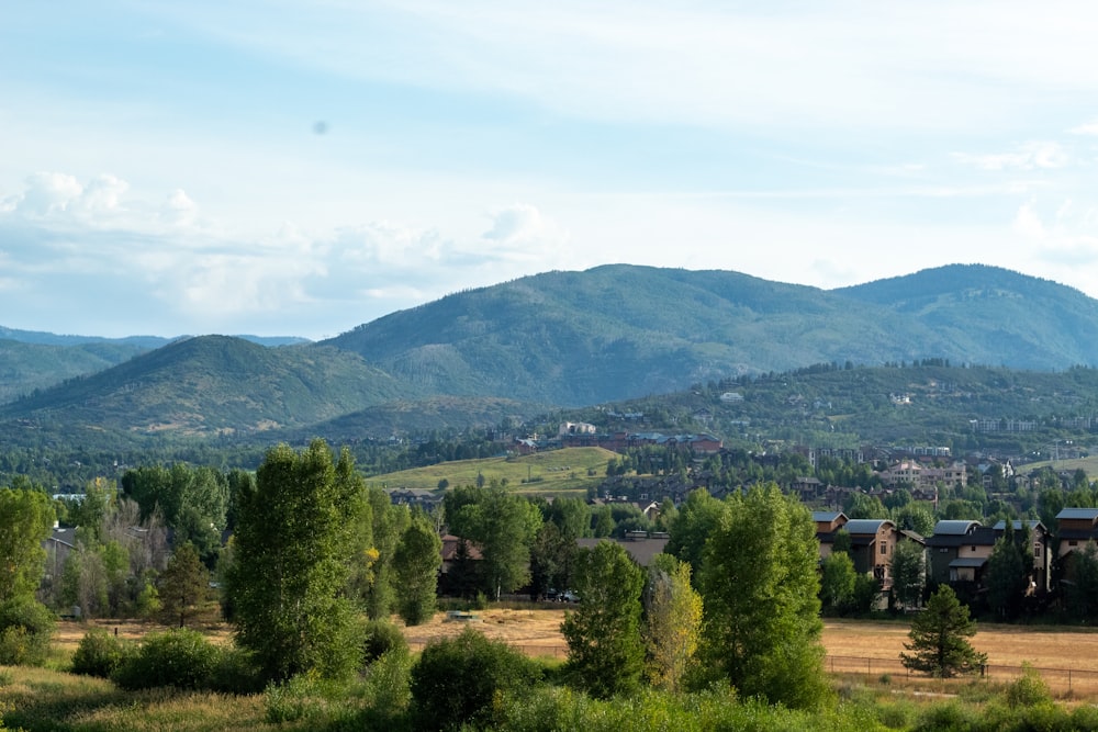 a scenic view of a town in the mountains