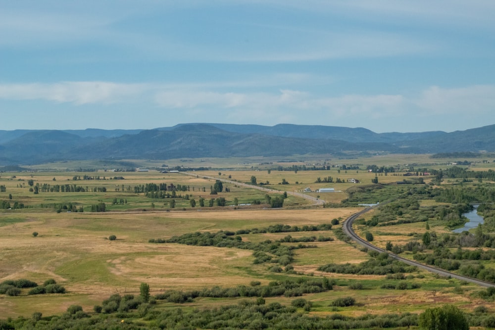 an aerial view of a highway in the middle of a field