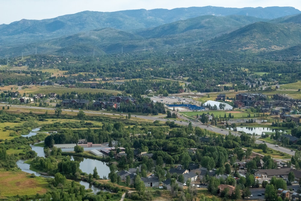 an aerial view of a town surrounded by mountains