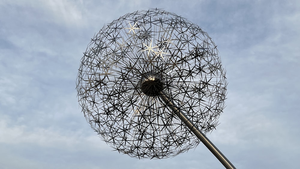 a large metal object in the air with a sky background