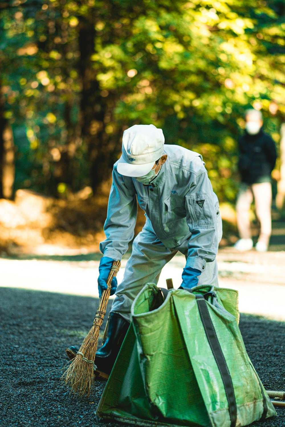 a man in a white hat is cleaning a bag