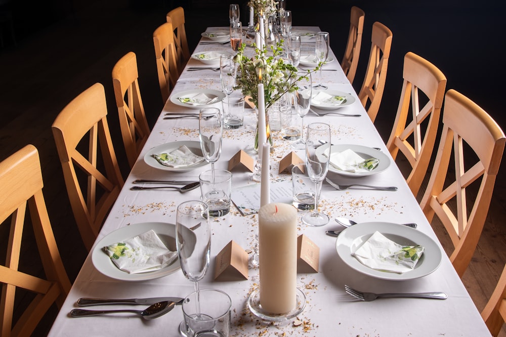 a long table set with plates and silverware