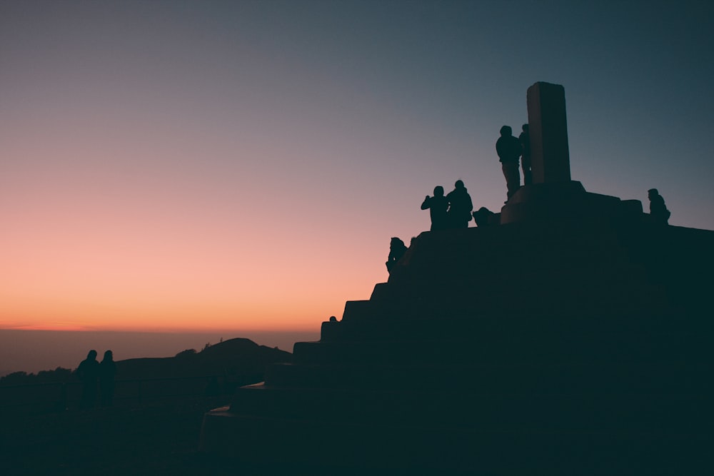 a group of people standing on top of a mountain