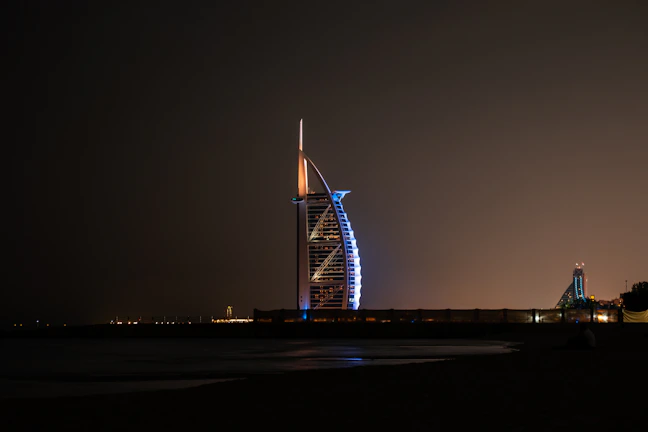 An elegant evening shot of الزامل’s corporate office illuminated against the night.