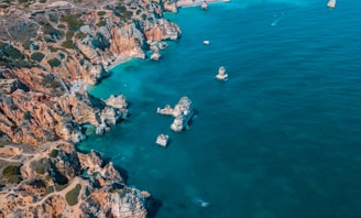 A panoramic view of the rugged cliffs and turquoise waters of the Canary Islands coastline.
