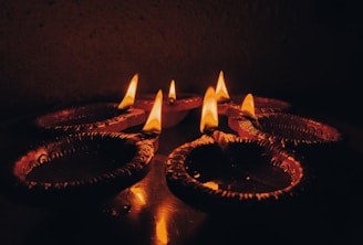 a group of lit candles sitting on top of a table