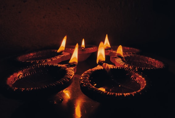 a group of lit candles sitting on top of a table