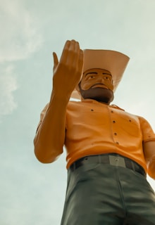 Bossman Hogg standing against a San Diego cityscape at sunset, embodying his roots.