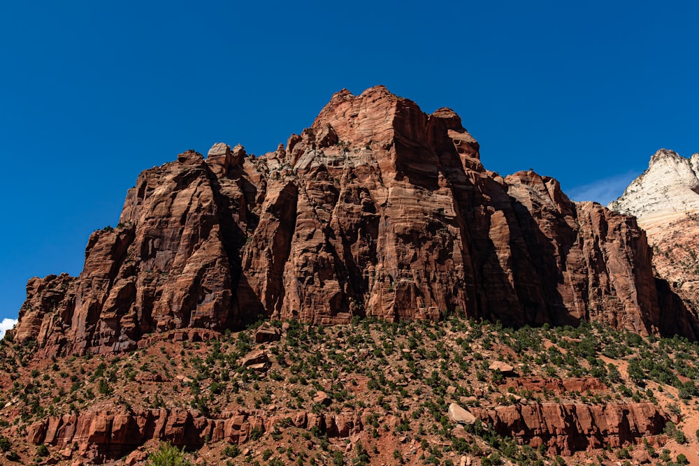 a very tall mountain with a blue sky in the background