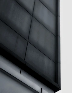 Modern architectural facade with sleek black and gray tones in an urban setting