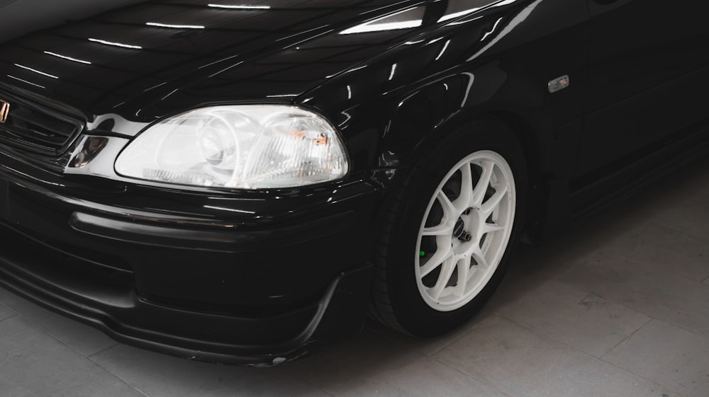 a black car is parked in a garage