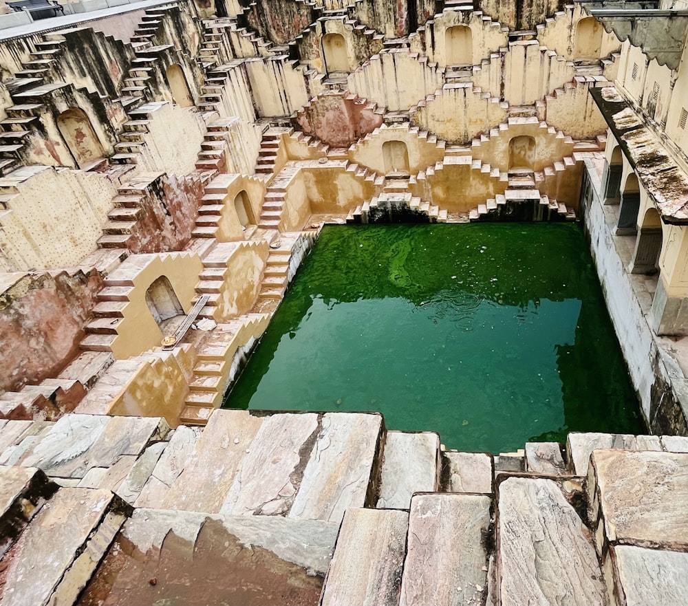 a large pool of water surrounded by stone walls