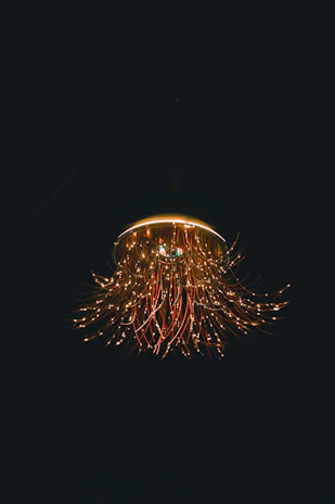 Elegant chandelier installation showcasing delicate wiring and craftsmanship.