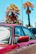 Side view of a luxury car with flawless, glossy paint reflecting palm trees.