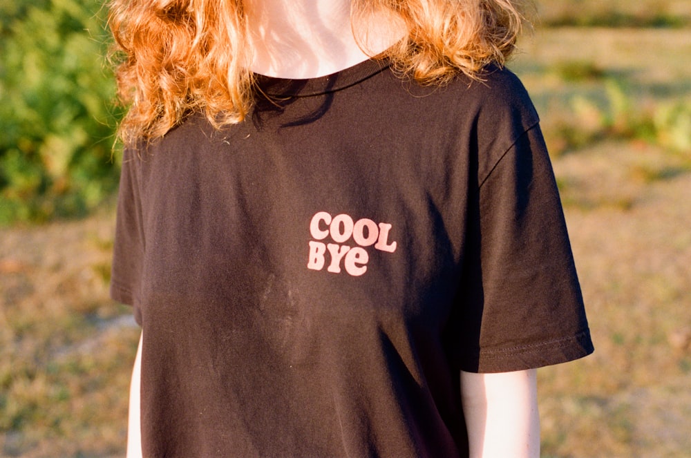 a woman with red hair wearing a black shirt