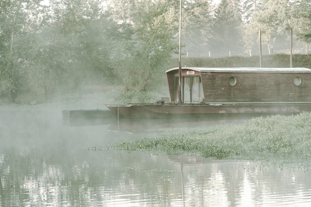 a boat is sitting on the water in the fog