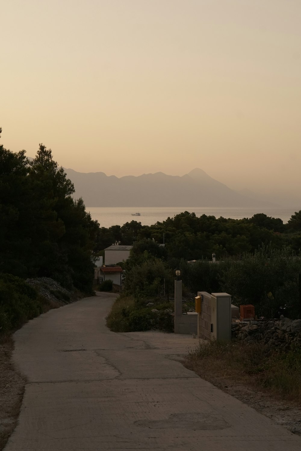 a paved path leading to a body of water