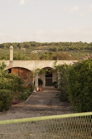 View of the guest house entrance surrounded by lush greenery.