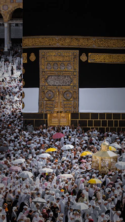 A crowd of people in white garments surrounding the Kaaba in Makkah, Saudi Arabia