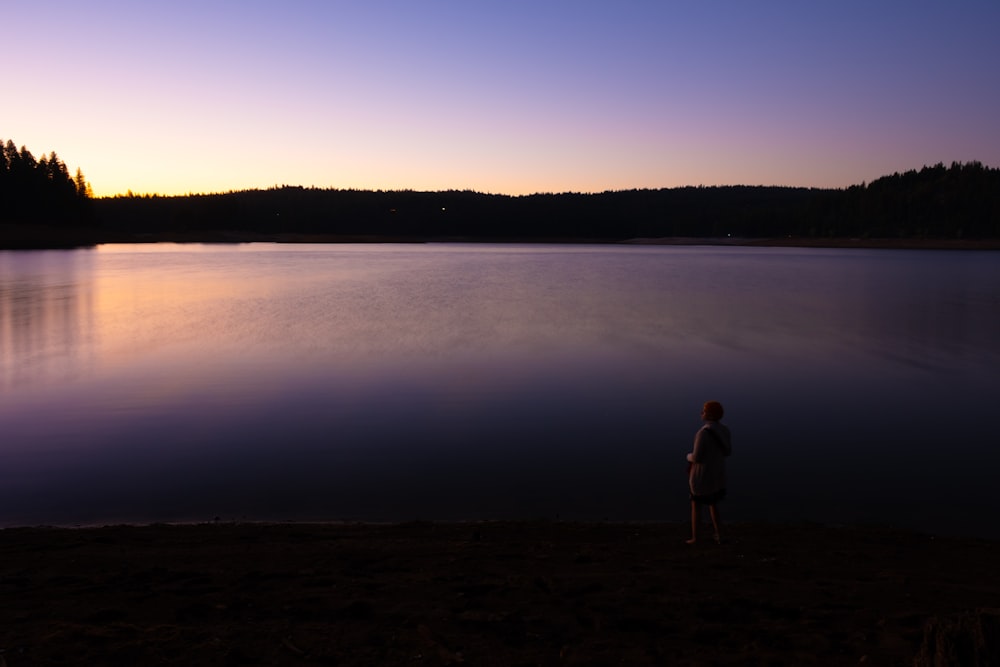 a person standing in front of a body of water