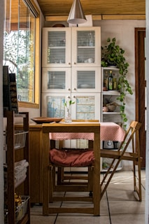 A cozy dining area with a wooden table and chairs.