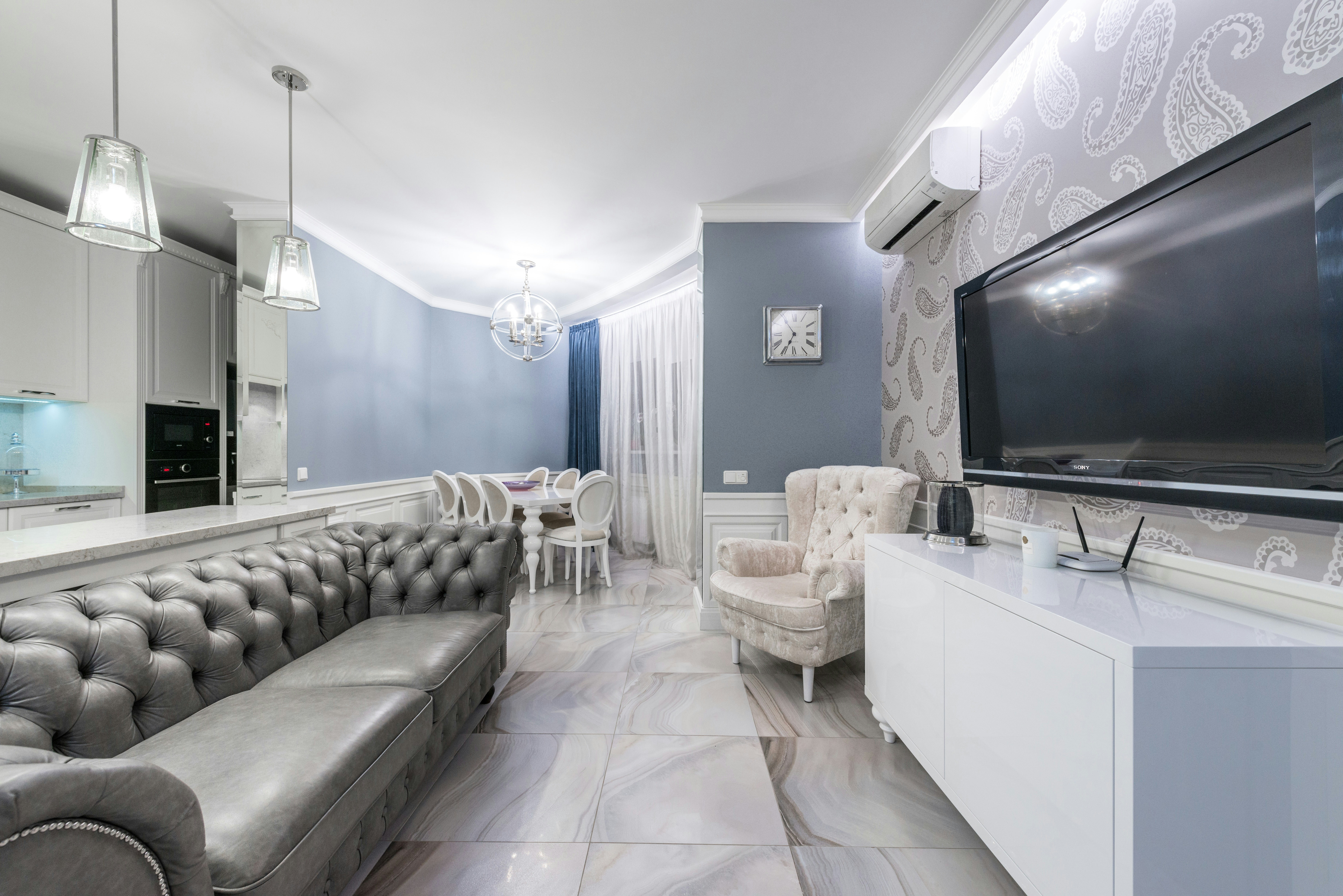 Living room with newly renovated flooring and smooth tile finishes.
