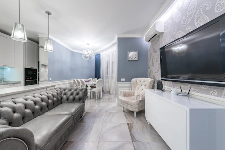 A sleek modern living room showcasing Luxora's high-tech decor solutions with ambient lighting and elegant furnishings.