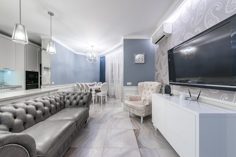 A bright, modern living room interior featuring custom kitchen set and sleek furniture designed by Vetira Interiors.