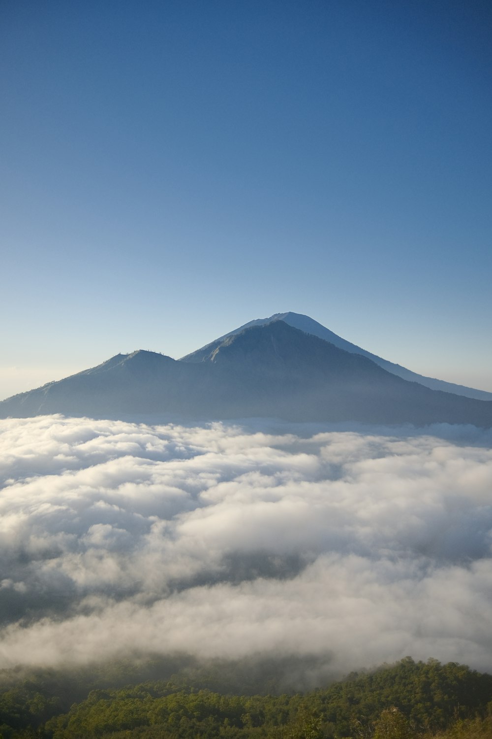 a view of the top of a mountain in the clouds