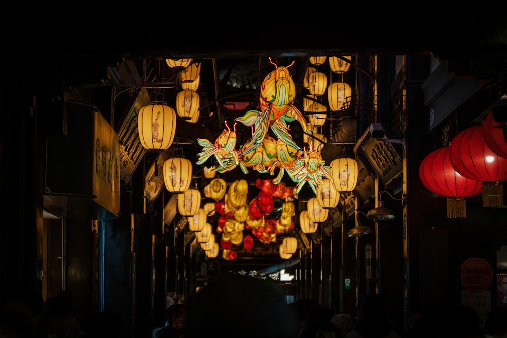 a group of lanterns hanging from the ceiling of a building