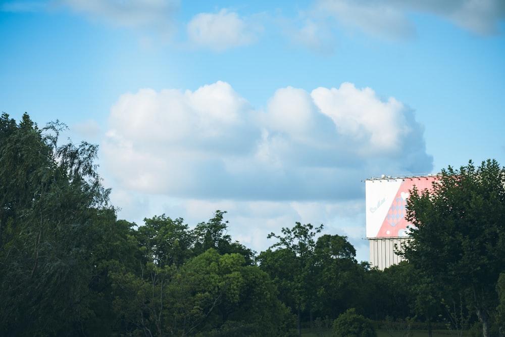 a tall white building with a red triangle on it's side