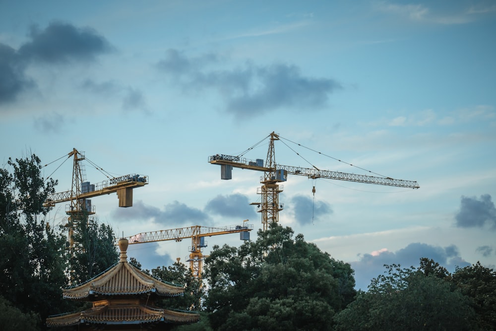 a group of cranes that are standing in the sky