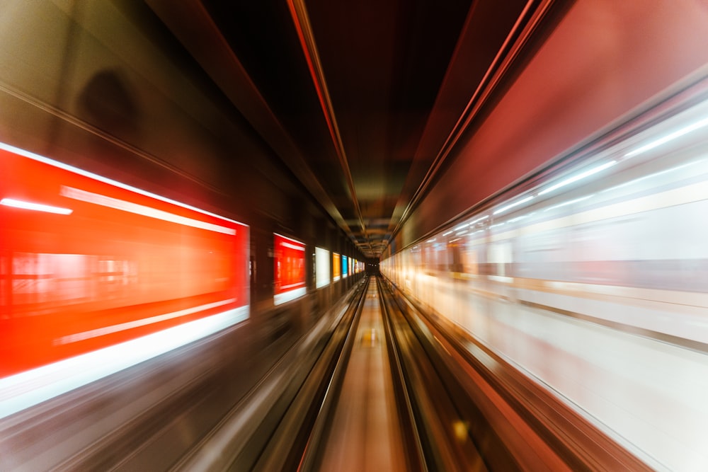 a blurry photo of a train going through a tunnel