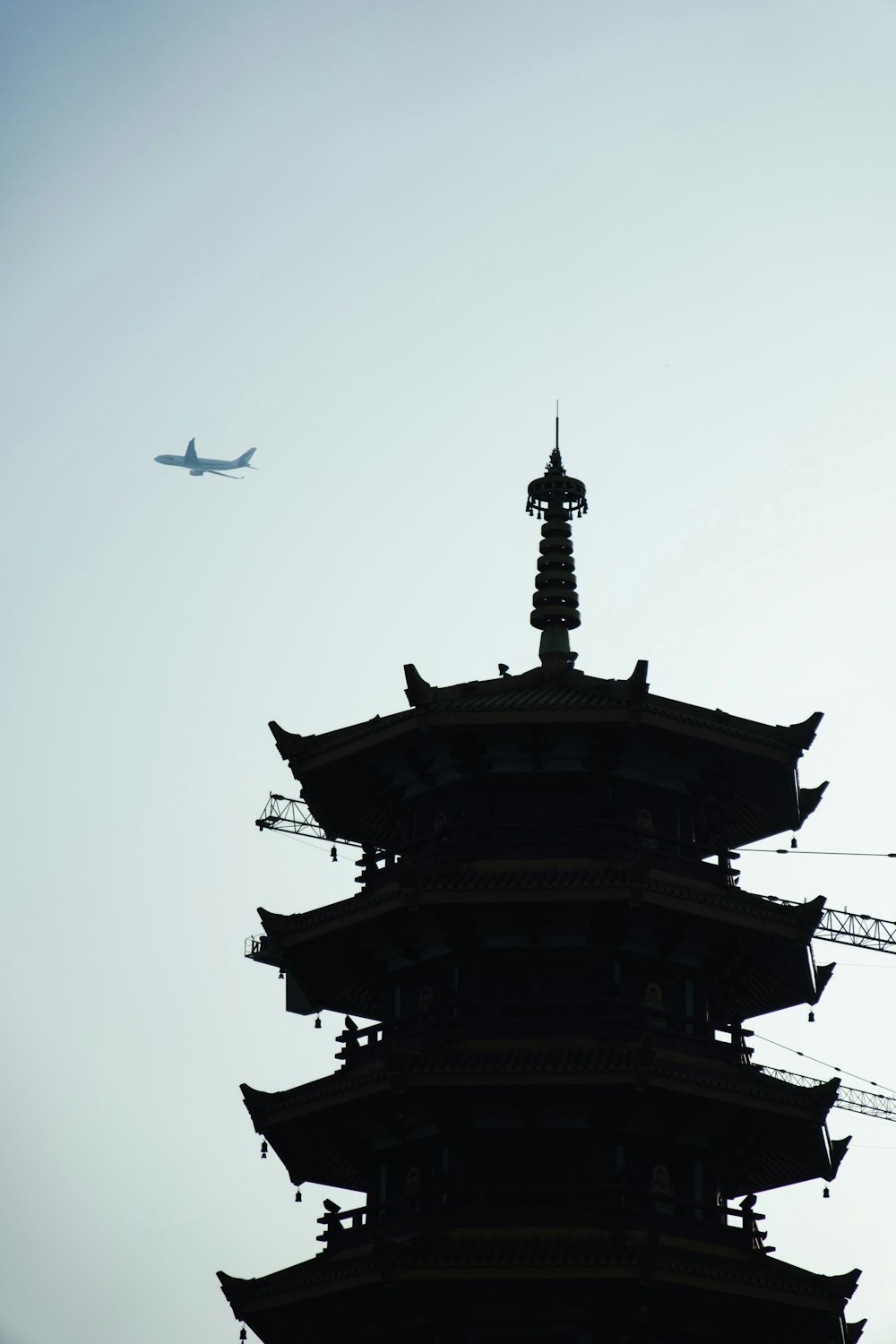 an airplane is flying over a tall building