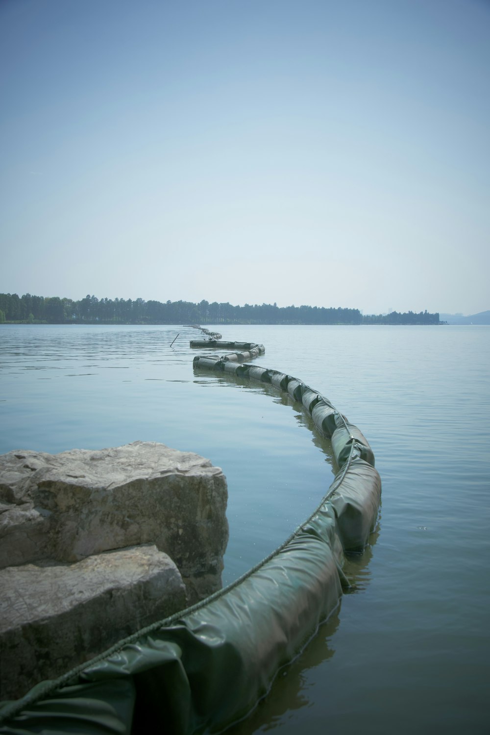 a large pipe is in the middle of a body of water