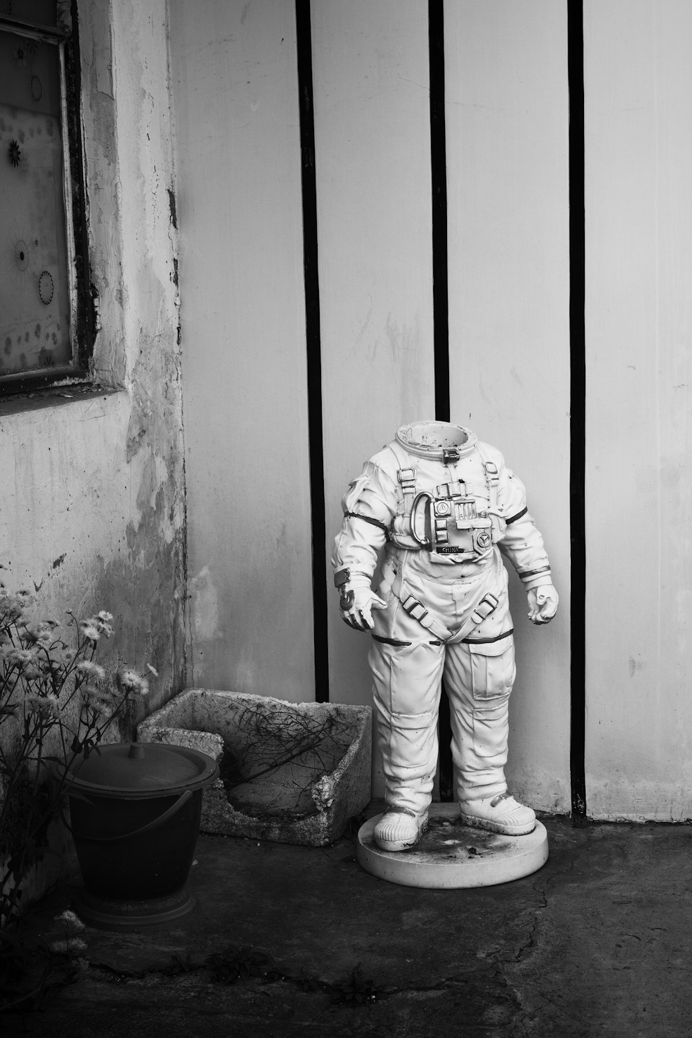 a black and white photo of a statue of an astronaut