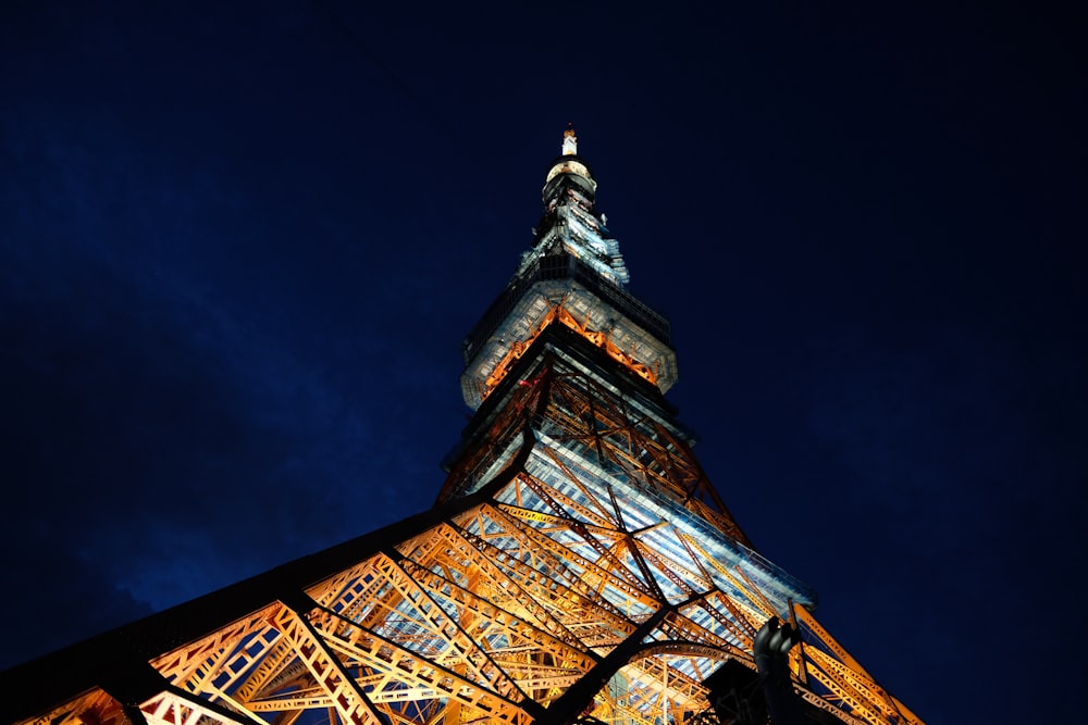 the eiffel tower is lit up at night