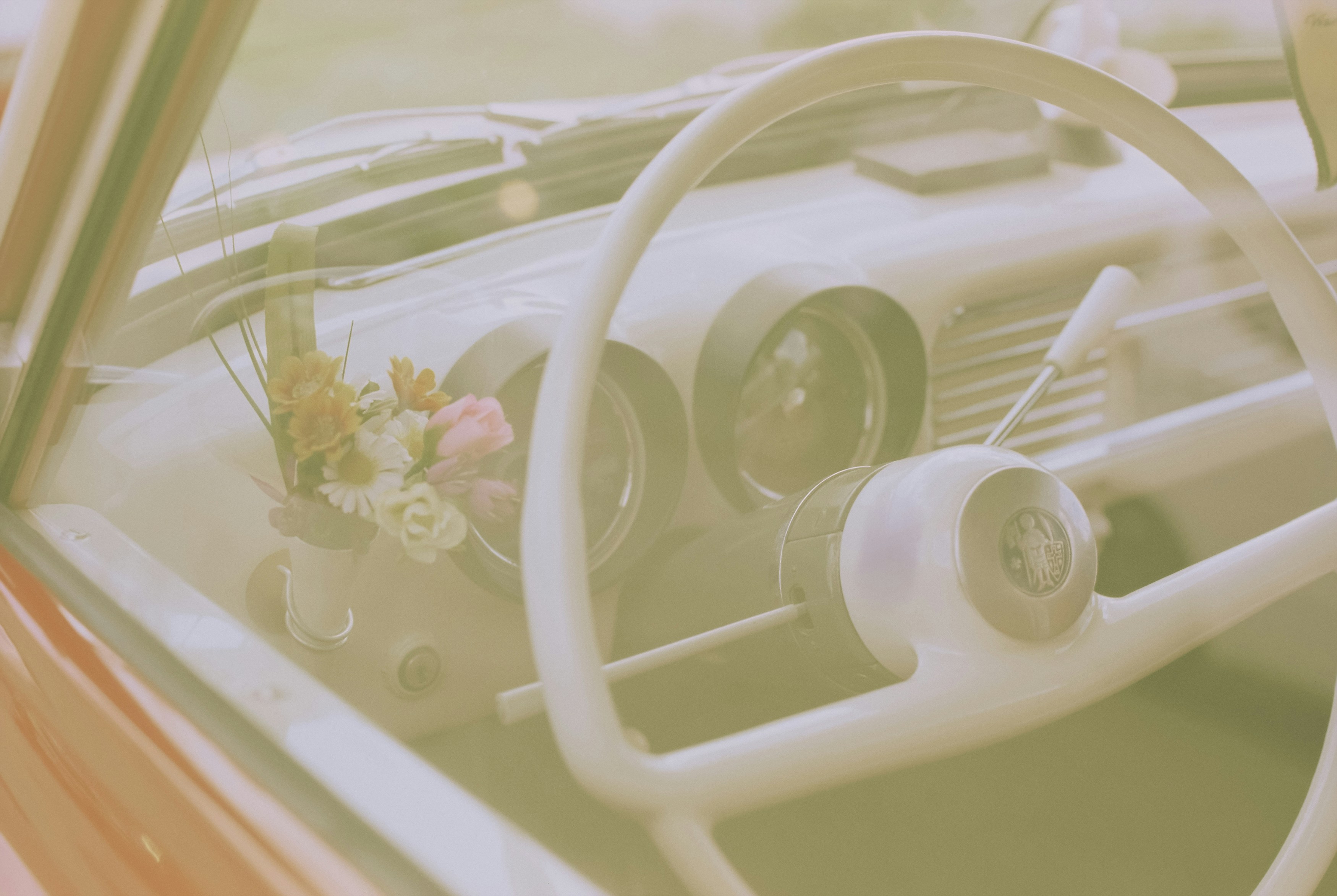 a car with a steering wheel and flowers in a vase