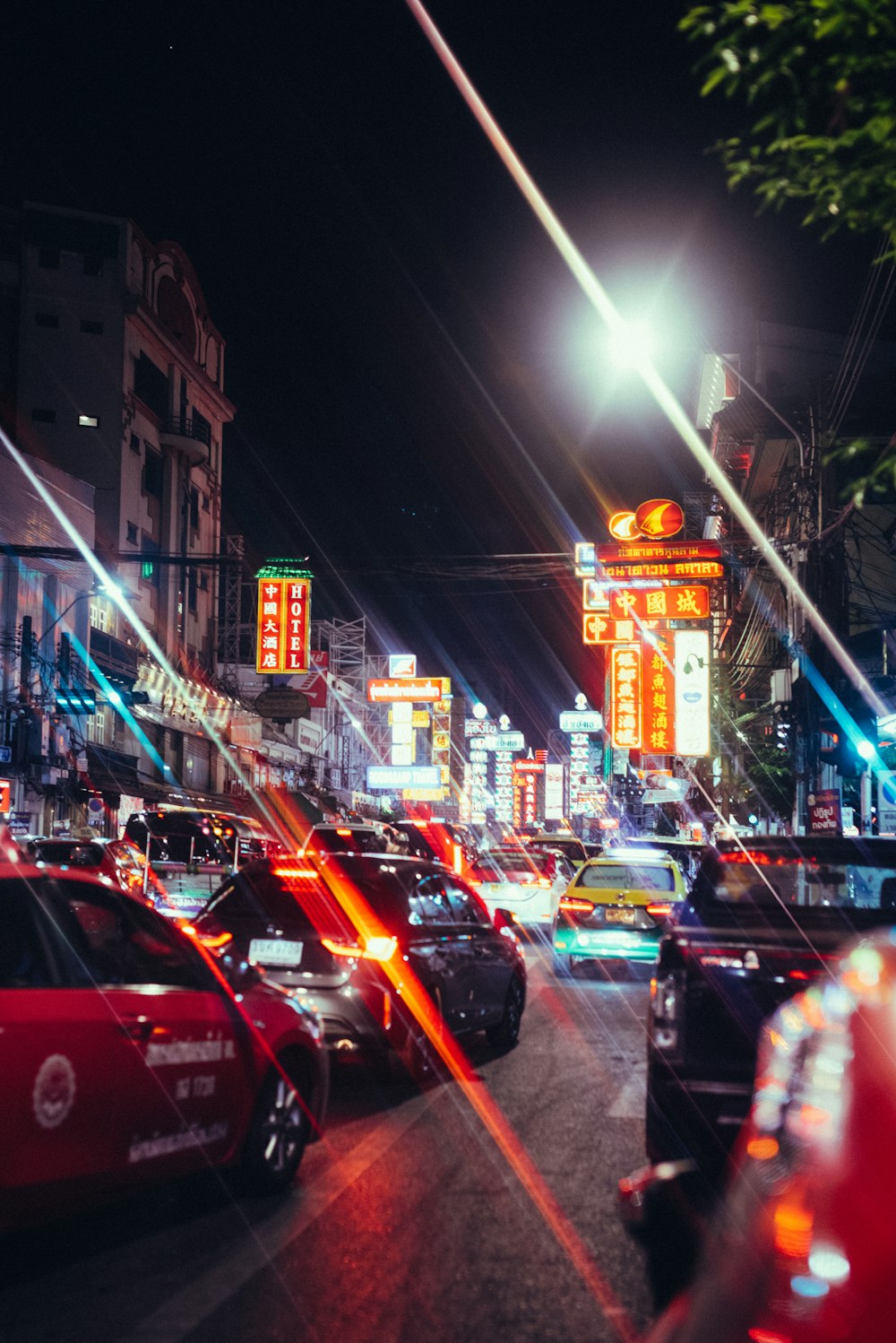 a city street filled with lots of traffic at night