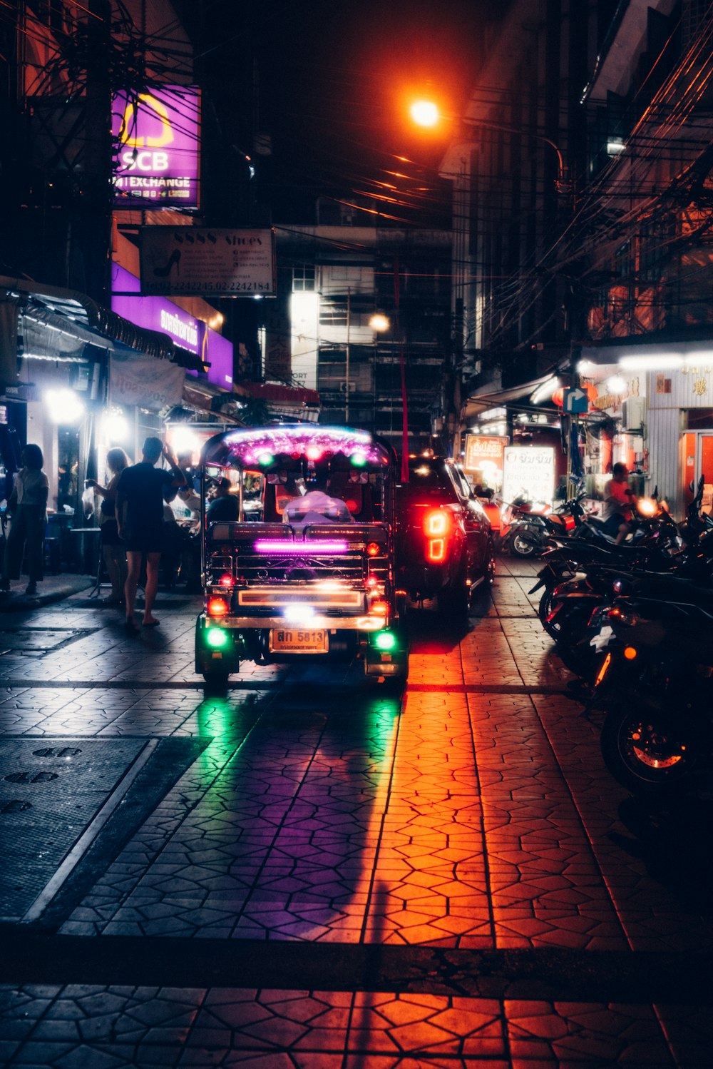 a truck driving down a street at night