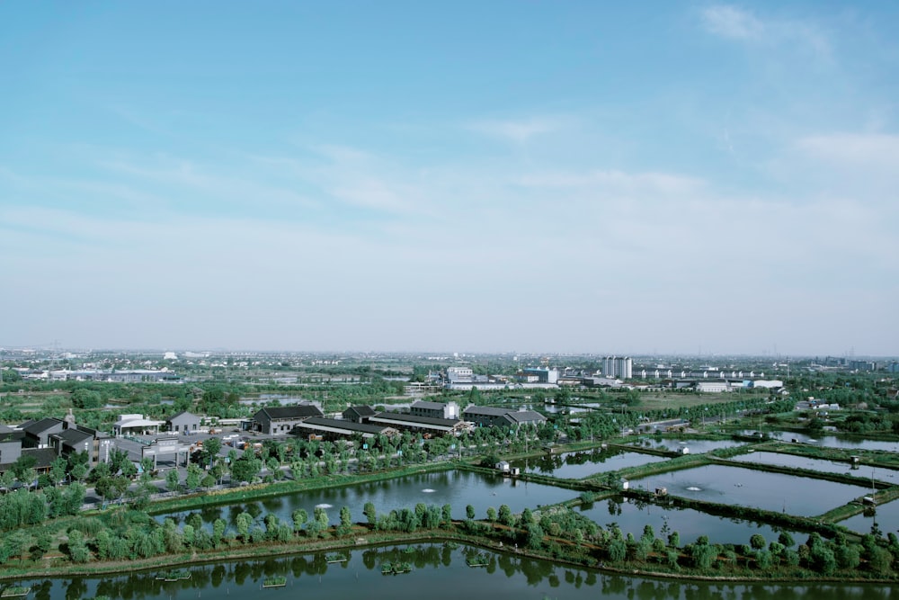 an aerial view of a city with a lake in the foreground